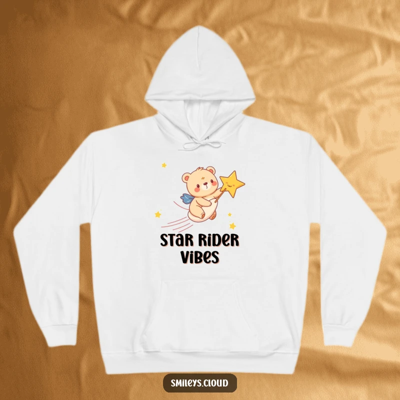 Funny hoodie showing a happy bear cub riding a shooting star with immense glee, perfect for staying warm on starry nights.