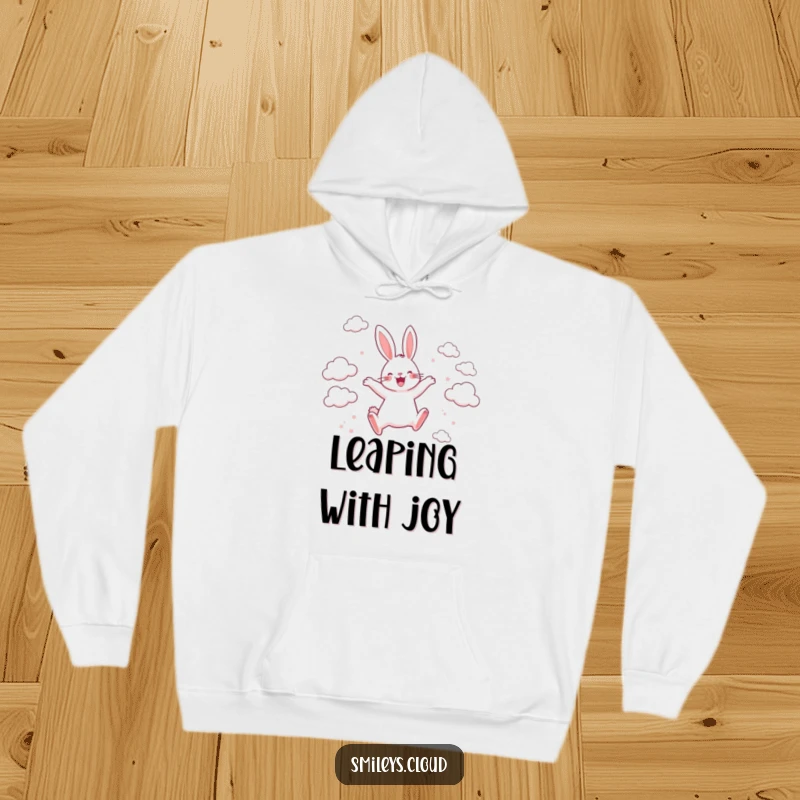 Funny hoodie depicting a happy rabbit leaping between scattered clouds with unbridled joy and playful exuberance, perfect for cozy adventures.